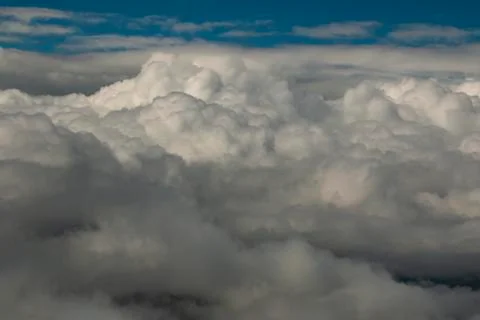 Flying above a dense layer of white clouds. Stock Photos