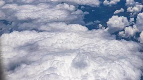 Flying above a dense layer of white clouds. Great and beautiful clouds. Stock Photos