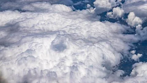 Flying above a dense layer of white clouds. Great and beautiful clouds. Stock Photos