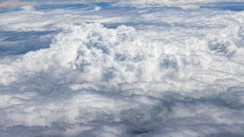Flying above a dense layer of white clouds. Great and beautiful clouds. Stock Photos