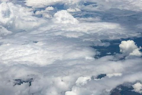 Flying above a dense layer of white clouds. Great and beautiful clouds. Stock Photos