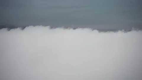 Flying above the dense white clouds. View from the helicopter. Parallax Stock Footage 274183300