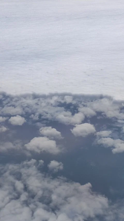 Flying above divided sea of clouds high angle vertical clip Stock Footage 295924635