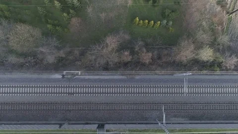Flying above ( dolly shot ) two empty railroad tracks, 4k Stock Footage 74250106