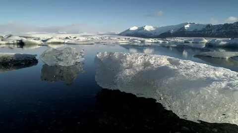 Flying above floating Icebergs. Ice from Glacier crystal shining. Ice Lagoon Stock Footage 108546545