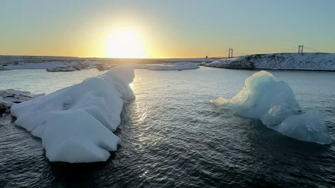 Flying above floating Icebergs. Ice from Glacier crystal shining. Ice Lagoon Stock Footage 108546647