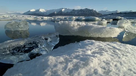 Flying above floating Icebergs. Ice from Glacier crystal shining. Ice Lagoon Stock Footage 108547428