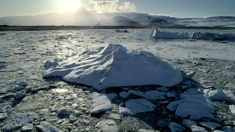 Flying above floating Icebergs. Ice from Glacier crystal shining. Ice Lagoon Stock Footage 108548167