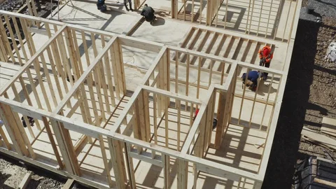 Flying above frame house under construction, aerial view of rooms and builders Stock Footage 129408818