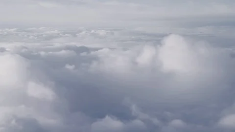 Flying above a grey clouds, high density cloudy sky, from a plane. Stock Footage