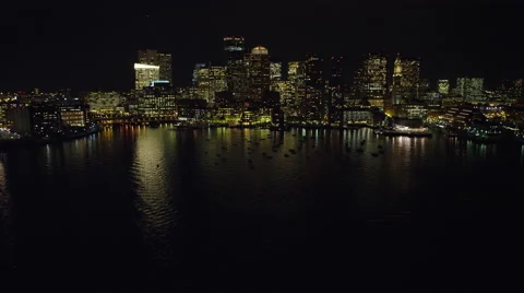 Flying above the harbor toward skyline of Boston's Financial District at night. Vídeo Stock 59249334