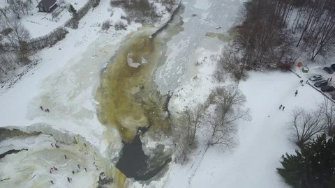 Flying above the iced river and waterfall Stockbeeldmateriaal 72633908