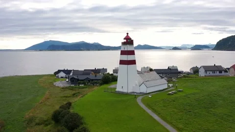 Flying above the iconic Alnes Lighthouse on a cloudy day, Aerial Orbit Stock Footage 215826473