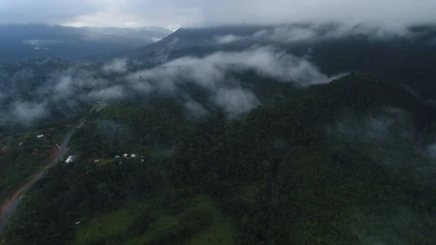 Flying above a jungle with clouds and mist Stock Footage 122690356