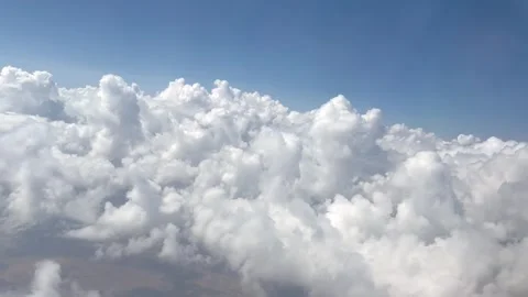 Flying above large white clouds against blue sky Stock Footage 343375986
