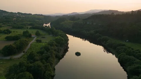 Flying Above Lima River At Sunset In Ponte De Lima, Portugal. wide aerial Stock Footage 248596041