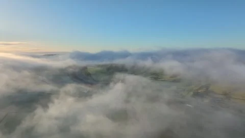Flying above low cloud and fog near M6 motorway towards patchwork farmland Video stock 276052929