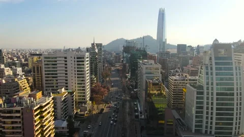 Flying above main road in between skyscrapers at golden hour in Santiago, Chile Vidéo 136012755