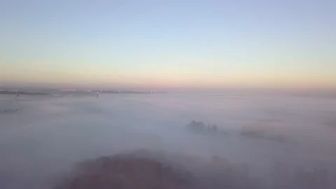 Flying above the mist with forest and city with chimney Stock Footage 229201595