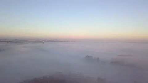 Flying above the mist with forest and city with chimney Stock Footage 229202147