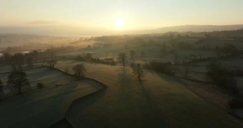 Flying above misty fields at sunrise Stock Footage 305090602