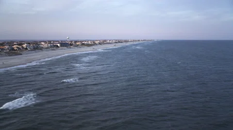 Flying above open water along shoreline of Long Beach Island, New Jersey at Stock Footage 59220143