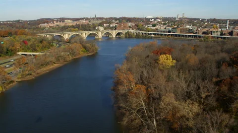 Flying above the Potomac River toward and over Key Bridge approaching Georgetown Stock Footage 59209121