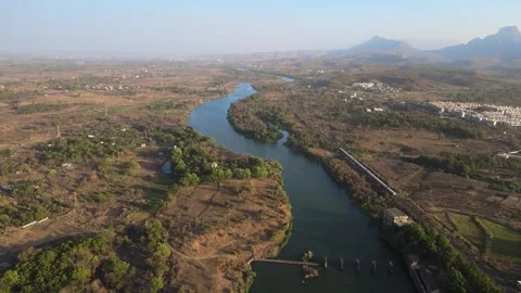Flying above the river and chasing train from the sky or aerial view of rive Video stock 156485401