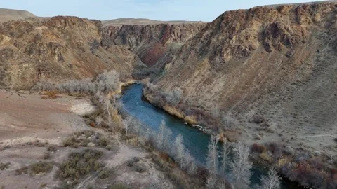 Flying above the river inside the Charyn canyon Stock Footage 325828440