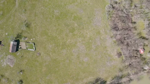 Flying above a small river with a concrete dam on it Stockbeeldmateriaal 151552696