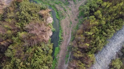 Flying above a small river. Top down shot, following water course. Stock Footage 159396100