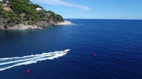 Flying above speeding boat on the blue sea Stock Footage 79792995