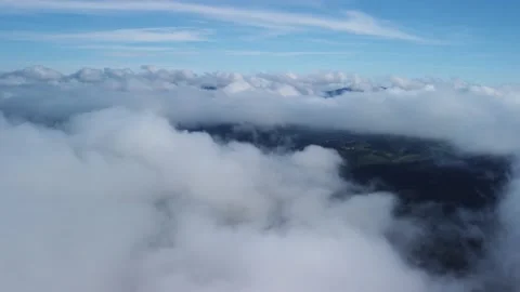 Flying above thick white clouds. ,hole in the clouds with a rural green Stock-Footage 221789118