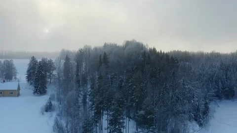 Flying up above thick winter clouds and large winter Sun to clear blue sky. Stock Footage 124612023