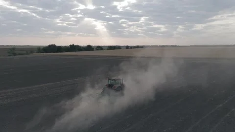 Flying Above Tractor Plowing Field In A Cloud Of Dirt Slow Motion Stock Footage 316712705