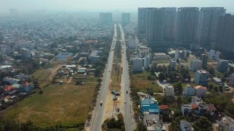 Flying above traffic in Saigon with opening panoramic view of the city with air Stock Footage 124010092