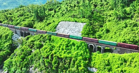 Flying above train rushing along the picturesque Hai Van Pass, Hue, Vietnam Stock Footage 342394532