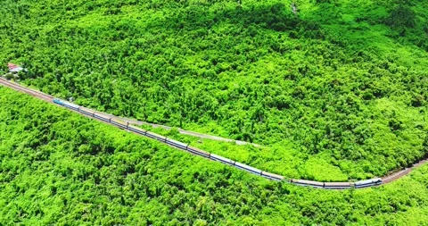 Flying above train rushing along the picturesque Hai Van Pass, Hue, Vietnam Video stock 342394595