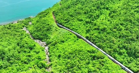 Flying above train rushing along the picturesque Hai Van Pass, Hue, Vietnam 库存影片 342394636