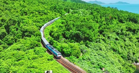 Flying above train rushing along the picturesque Hai Van Pass, Hue, Vietnam 스톡 동영상 342394762