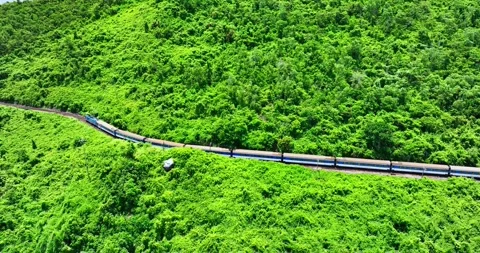 Flying above train rushing along the picturesque Hai Van Pass, Hue, Vietnam Stock Footage 342394847