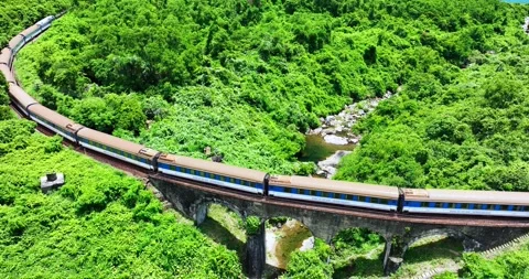 Flying above train rushing along the picturesque Hai Van Pass, Hue, Vietnam Video stock 342394935