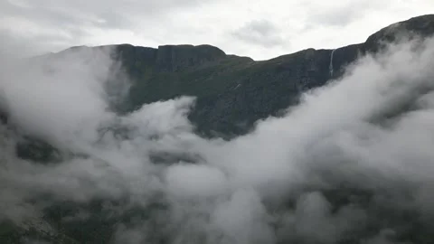 Flying above a valley with clouds  Stock Footage 252257379