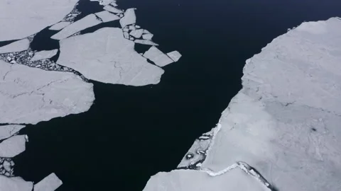 Flying above water surface with floating ice, drone view. Stock Footage 231015969