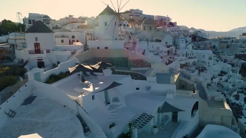Flying above white houses and famous old castle ruins on Santorini, Greece Stock Footage 80565899