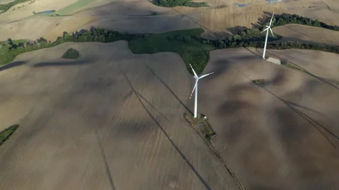 Flying Above Wind Turbines In A Wind Farm Energy Production On Open Grass Field Video stock 138442070