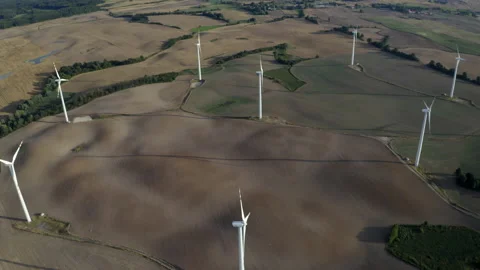 Flying Above Wind Turbines In A Wind Farm On Open Grass Field Stock Footage 138442358