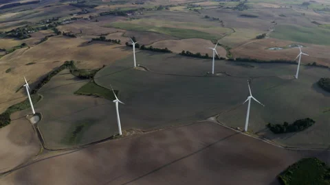Flying Above Wind Turbines In A Wind Farm Energy Production On Open Grass Field Stock Footage 138443043