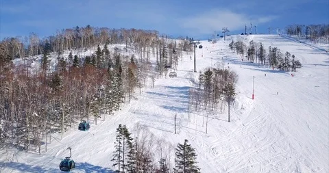 Flying abve the ski slope of ski resort and aerial view of ski lift elevator Stock Footage 88485885