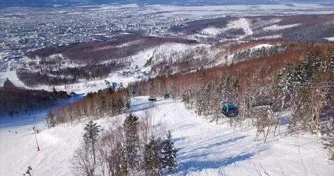 Flying abve the ski slope of ski resort and aerial view of ski lift elevator Stock Footage 88486004